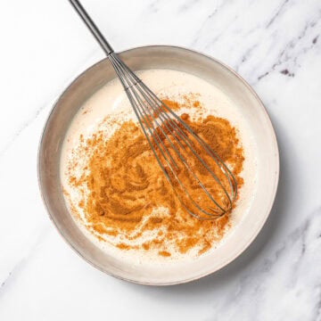 Whisking vegan French toast batter in bowl.