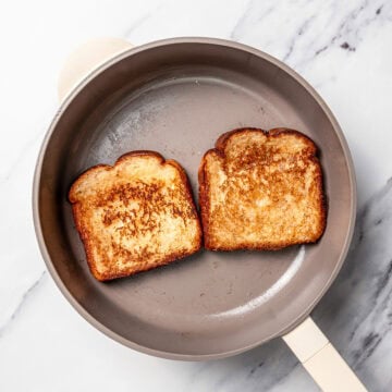 Two slices of French toast in skillet.