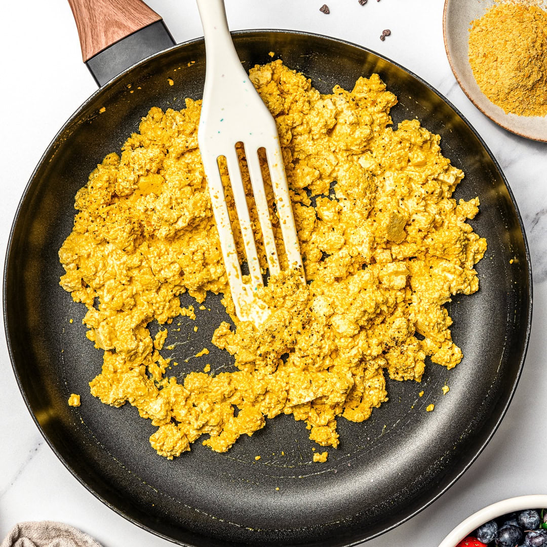 Spatula in skillet of tofu scramble.