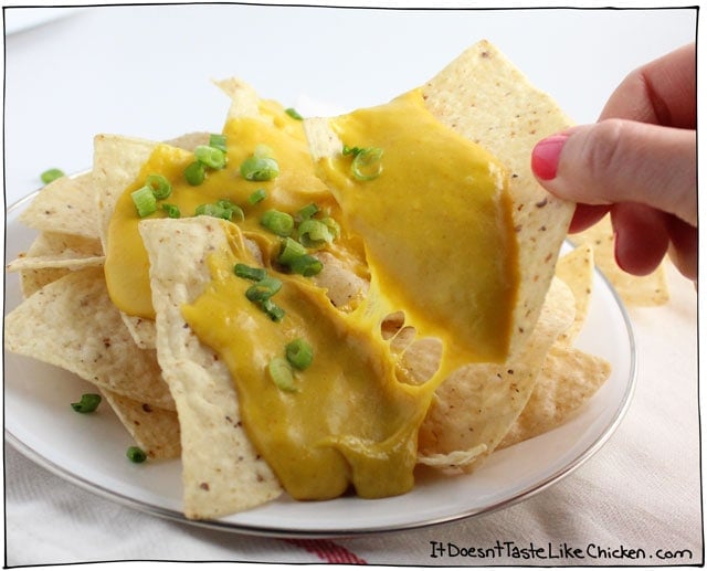 Vegan Nacho Cheese! Only 15 minutes to make this melty, stretchy, gooey, dairy-free cheese. Pour it on nachos, serve it on a baked potato, use it in a quesadilla, or wherever you desire. #itdoesnttastelikechicken #veganrecipes #vegancheese