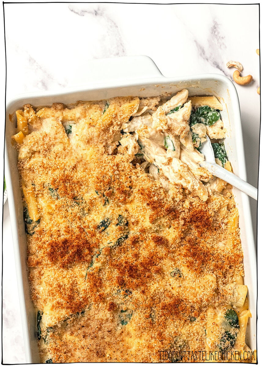 Casserole dish with spinach artichoke pasta bake.