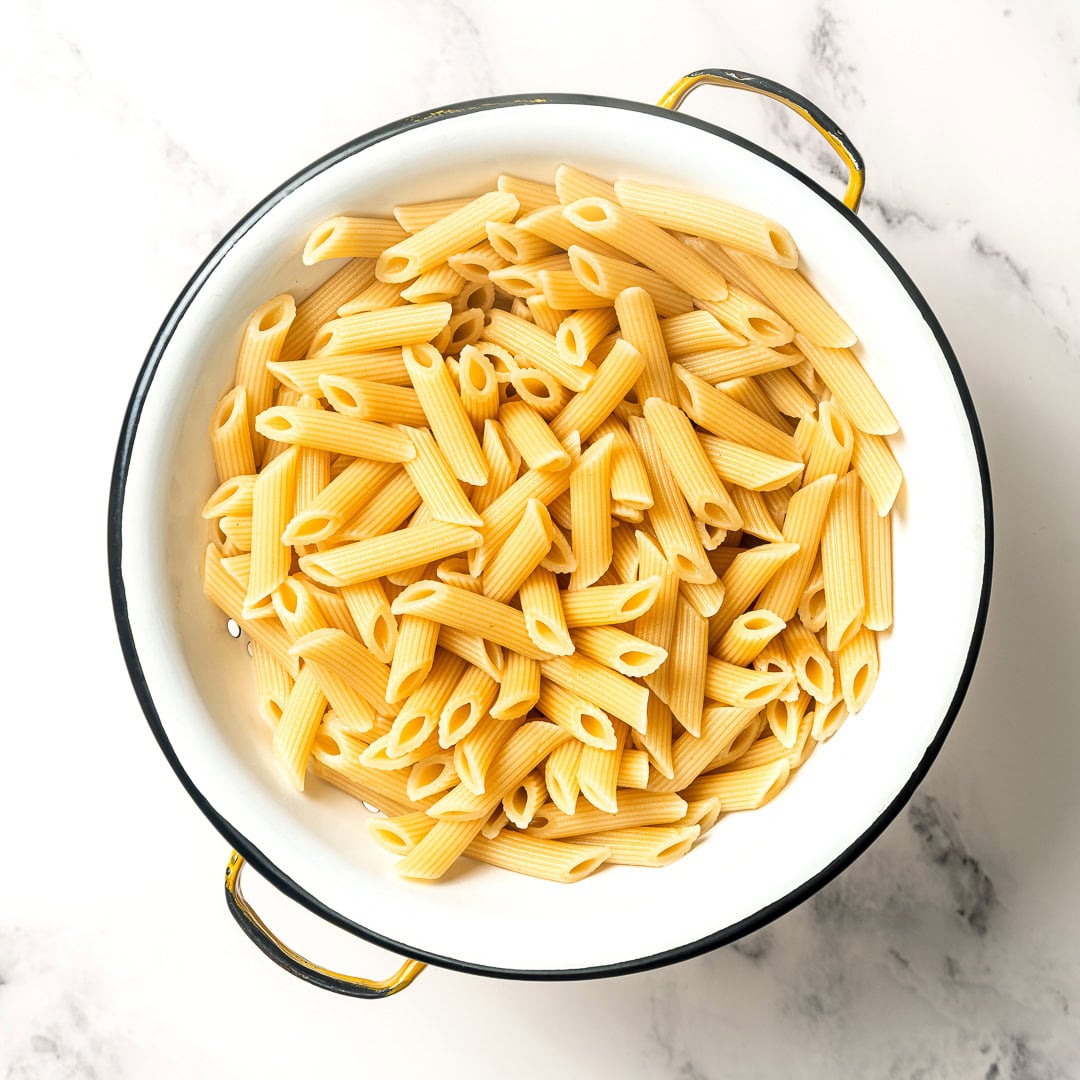 Cooked pasta in colander.