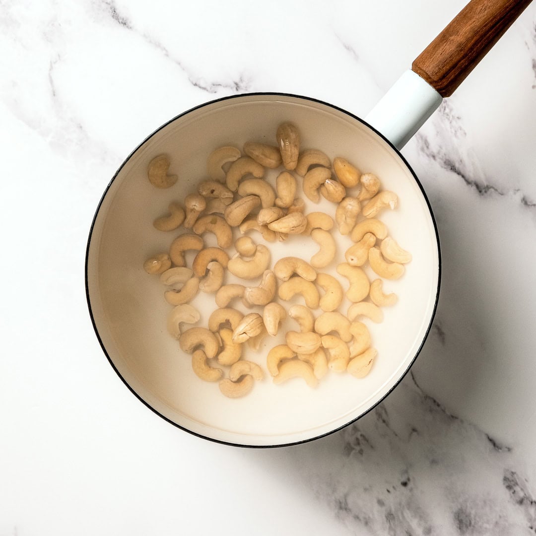 Saucepan with cashews boiling in water to soften them.