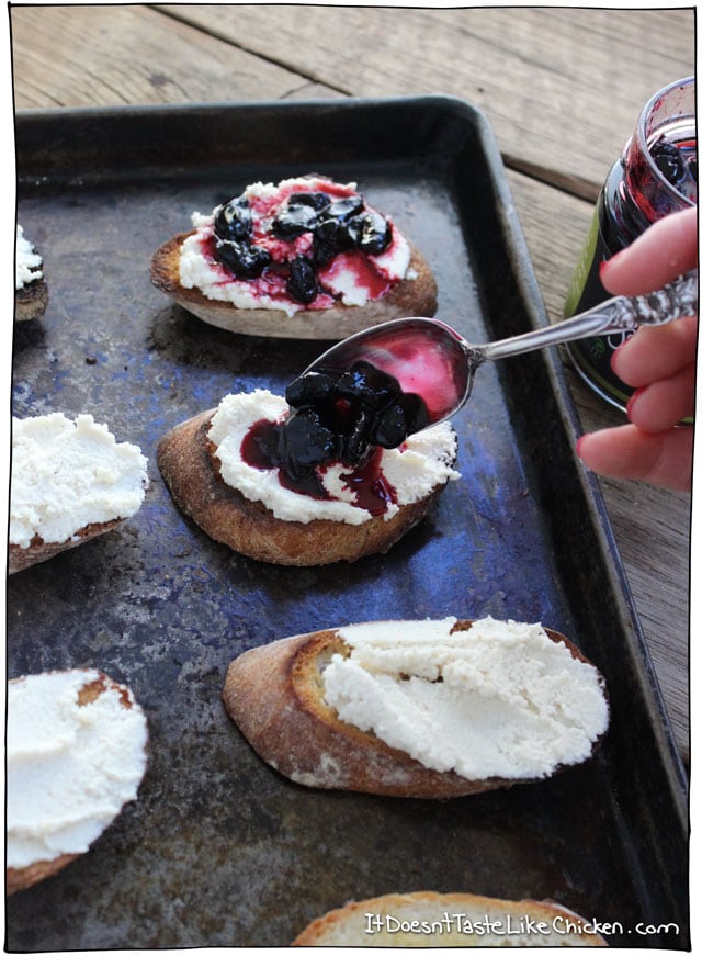 Macadamia Ricotta and Haskap Crostini! This makes such a cute and easy vegan appetizer. Recipe for vegan macadamia ricotta, toast baguette slices, then top with a haskap berry relish! #itdoesnttastelikechicken