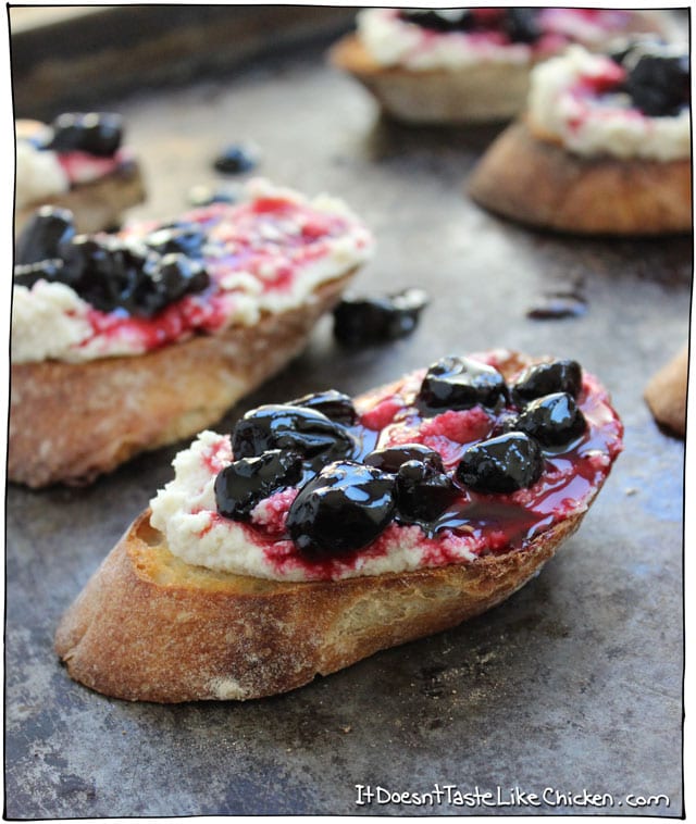 Macadamia Ricotta and Haskap Crostini! This makes such a cute and easy vegan appetizer. Recipe for vegan macadamia ricotta, toast baguette slices, then top with a haskap berry relish! #itdoesnttastelikechicken
