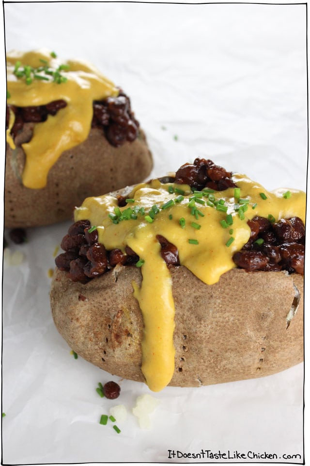 This Vegan Loaded Baked Potato has lightly crisp skin on the outside, and is fluffy in the middle, layered with BBQ beans, and easy to prepare dairy free nacho cheese. So delicious! #itdoesnttastelikechicken