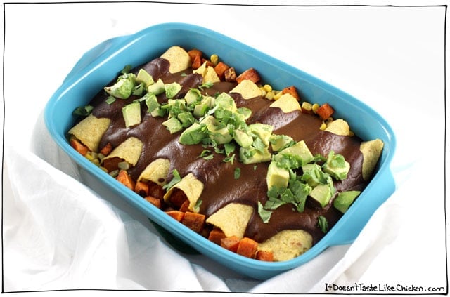 These vegan Sweet Potato & Corn Enchiladas with Mole Sauce are so flavour-packed they will satisfy everyone! Pretty quick and easy to make too. Topped with avocado makes a perfect Mexican inspired weeknight meal. Vegetarian and gluten free #itdoesnttastelikechicken