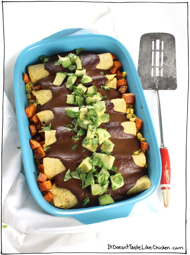 These vegan Sweet Potato & Corn Enchiladas with Mole Sauce are so flavour-packed they will satisfy everyone! Pretty quick and easy to make too. Topped with avocado makes a perfect Mexican inspired weeknight meal. Vegetarian and gluten free #itdoesnttastelikechicken