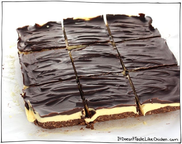 Perfect Vegan Nanaimo Bars! This Canadian classic dessert is made up of a coconut and chocolate cookie base, a creamy custard layer, all topped with chocolate. Dairy free, egg free, gluten-free. #itdoesnttastelikechicken