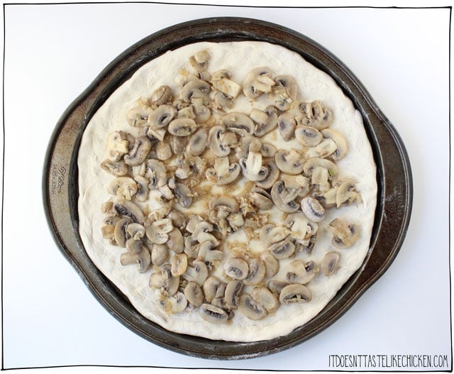 Creamy Vegan Coconut Mushroom Pizza! This decadent mushroom lovers pizza is covered in a rich dairy-free coconut sauce that bubbles and browns to perfection in the oven. #itdoesnttastelikechicken