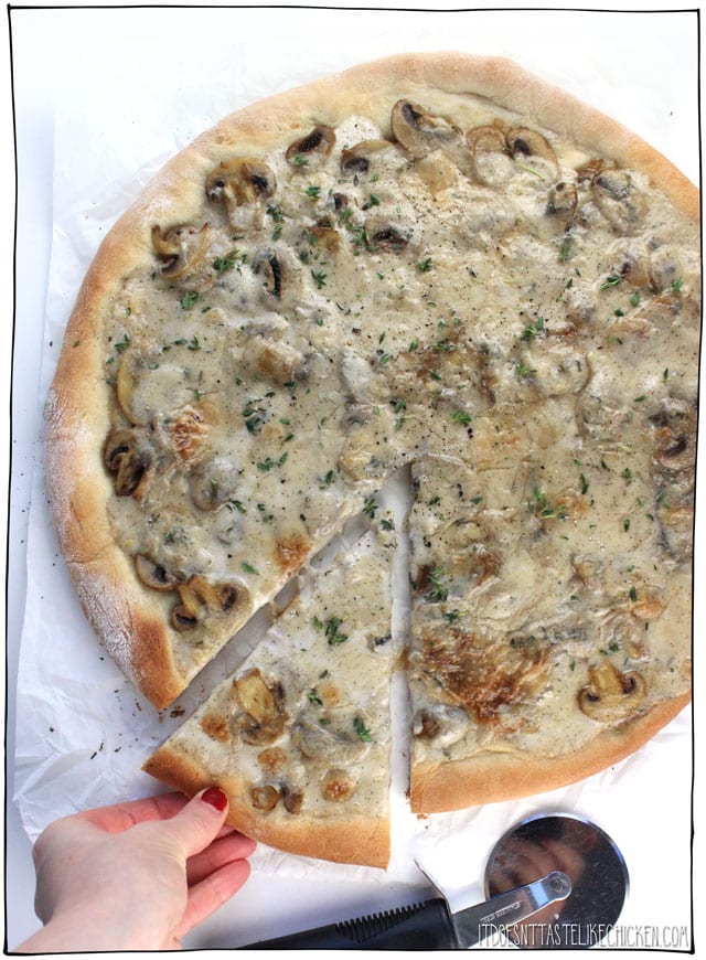 Creamy Vegan Coconut Mushroom Pizza! This decadent mushroom lovers pizza is covered in a rich dairy-free coconut sauce that bubbles and browns to perfection in the oven. #itdoesnttastelikechicken