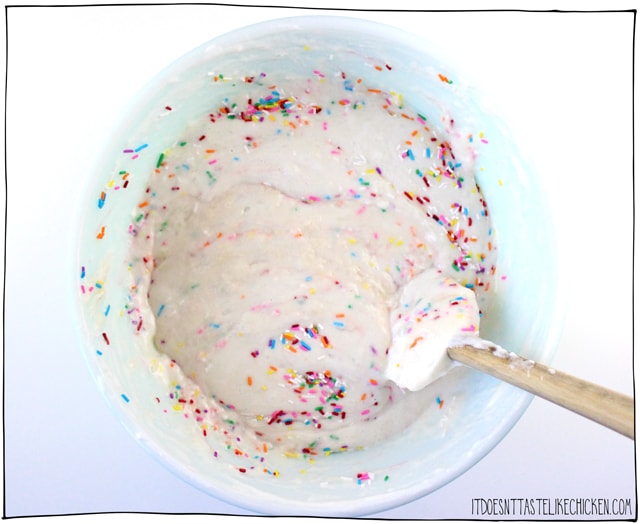 Vegan Confetti Cake! A delicious vanilla cake with sprinkles stirred into the batter to make spots of bright color throughout. Perfect for a vegan birthday cake! Deliciously moist and sweet, this rainbow cake is perfect for a birthday party. #itdoesnttastelikechicken #veganrecipes #vegandesserts #vegancake