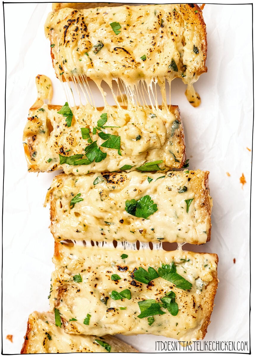 Vegan garlic bread with cheese on parchment paper.