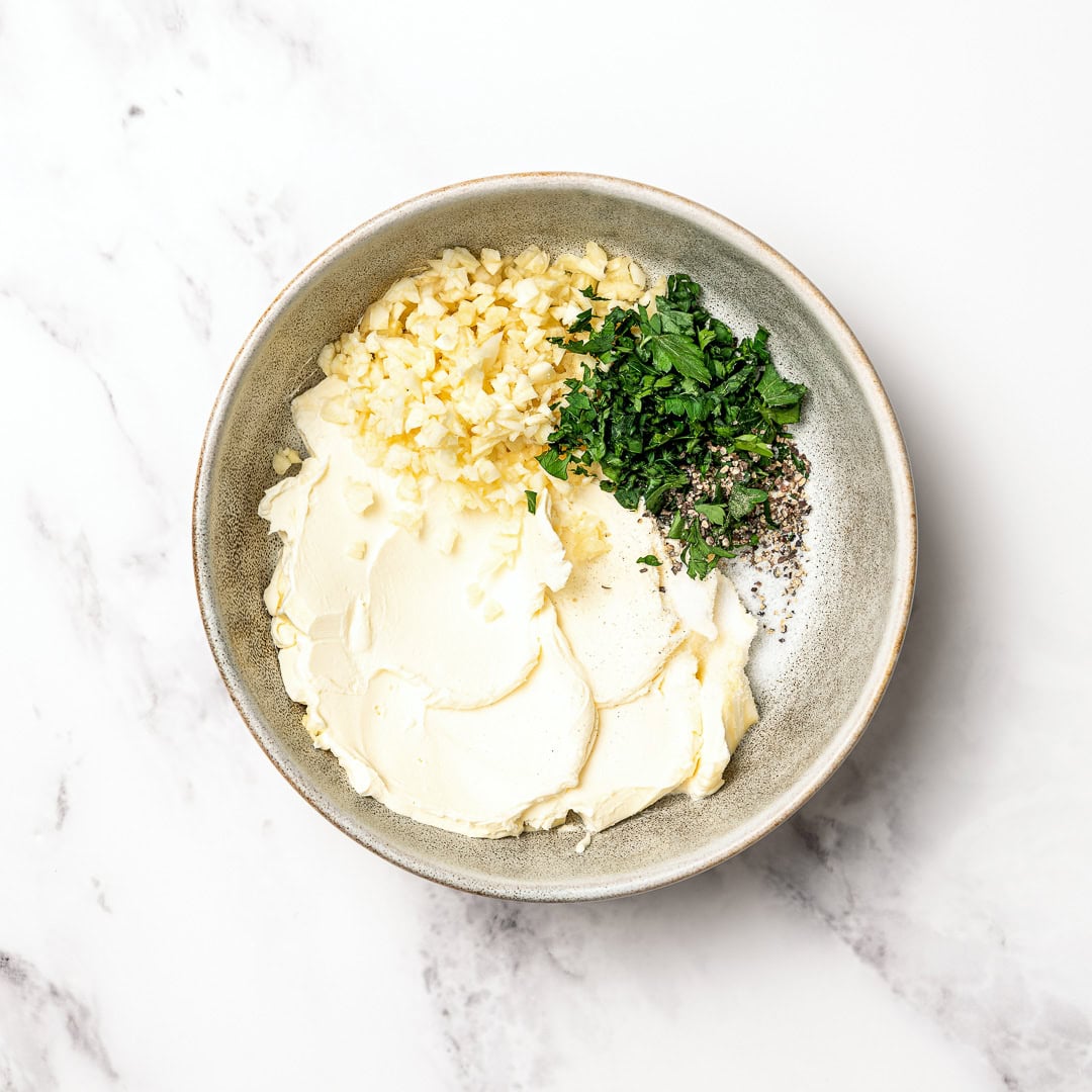 Ingredients for garlic butter in bowl.