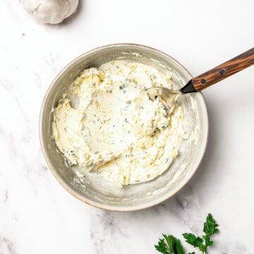 Garlic butter in bowl with spoon.