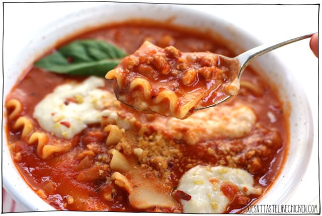 The Best Vegan Lasagna Soup! This easy to prepare soup is made with homemade beefy tofu crumbles, a simple tomato soup base, and lasagna noodles cooked right in the soup. Top with melty dairy-free cheese and fresh basil, all in a bowl of pure comfort food bliss! #itdoesnttastelikechicken #veganrecipes #lasagna