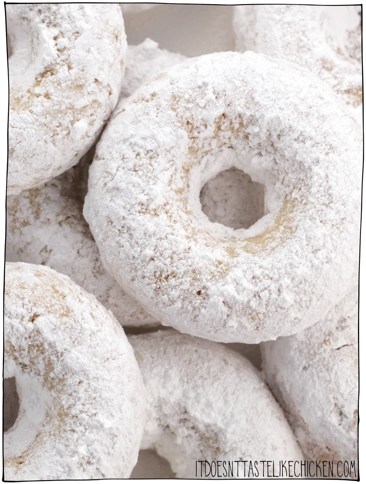 Vegan Powdered Donuts! Homemade donuts are easy to make and taste just like old fashioned white sugar powdered donuts. These baked donuts are the perfect dessert or snack! #itdoesnttastelikechicken #veganrecipes #donuts #veganbaking