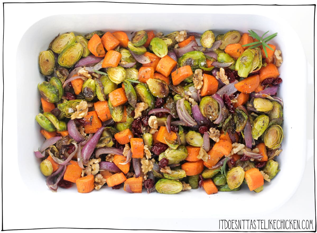The Best Roasted Vegetables for Thanksgiving! Easy to make with crispy Brussels sprouts, hearty carrots, sweet red onion, crunchy toasted walnuts, sweet cranberries, and just a tiny touch of cinnamon. Now I know that I advertised these vegetables as being the perfect Thanksgiving side (and they really are), but these veg are so scrumptious you might find yourself prepping them all winter long. #itdoesnttastelikechicken #veganrecipes #thanksgiving