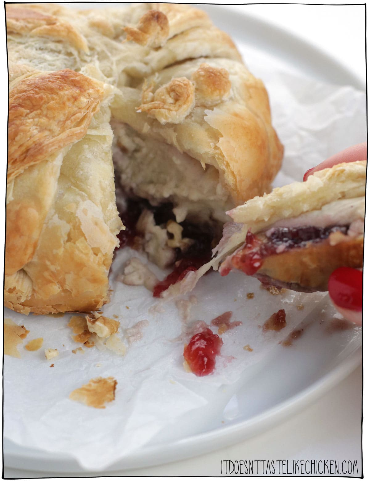 This Vegan Baked Brie in Puff Pastry is the stuff of holiday appetizer dreams!!!! Gooey homemade easy-to-make vegan brie cheese is paired with cranberry sauce, walnuts, and wrapped up in flaky crispy puff pastry. Don't be surprised when this gets gobbled up at lightning speed. The perfect appetizer for Christmas, Thanksgiving, or any holiday party. #itdoesnttastelikechicken #veganappetizer #veganchristmas #vegancheese