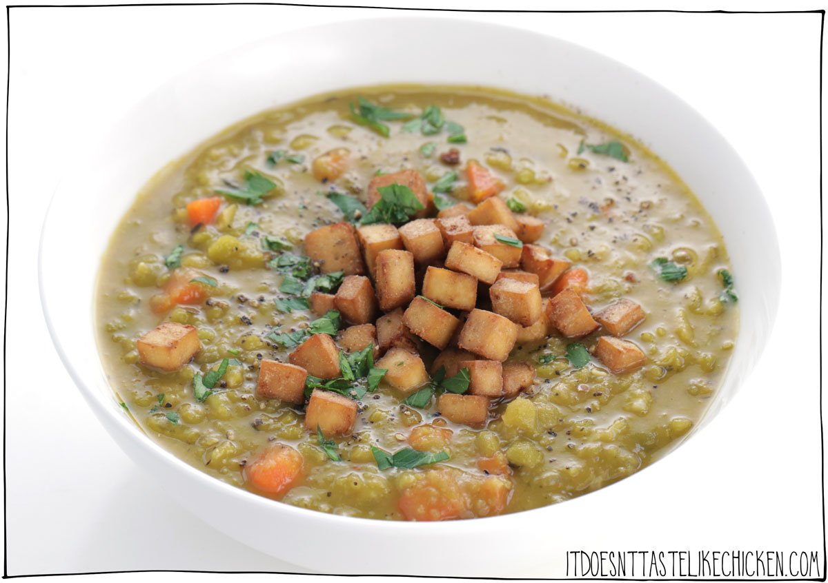 Easy Vegan Split Pea Soup with Smoky Tofu Ham! Hearty, flavor-packed, warming, and lick the bowl scrumptious! There is a reason this classic soup recipe is a staple for many: it's easy to make, it uses inexpensive ingredients, and oh my is it ever delicious. The perfect make-ahead meal. #itdoesnttastelikechicken #veganrecipes #soup