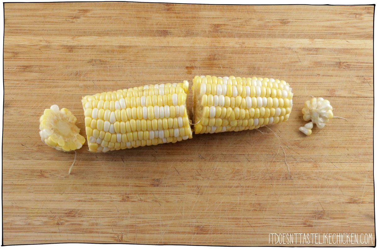 Cut the top and bottom off the corn and then cut the cob in half.