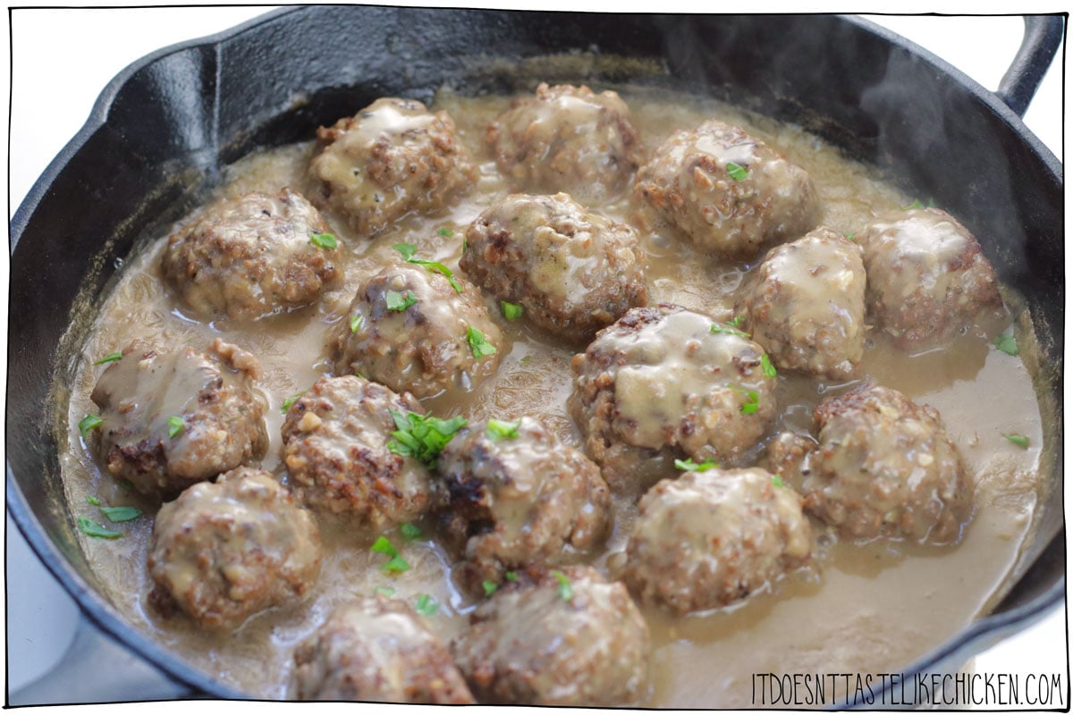 These Vegan Swedish Meatballs are so meaty, that you might just fool a meat eater! Delicious homemade seitan meatballs are covered in a rich and creamy gravy for the ultimate comfort food. These taste better than IKEA's! #itdoesnttastelikechicken #vegan #seitan