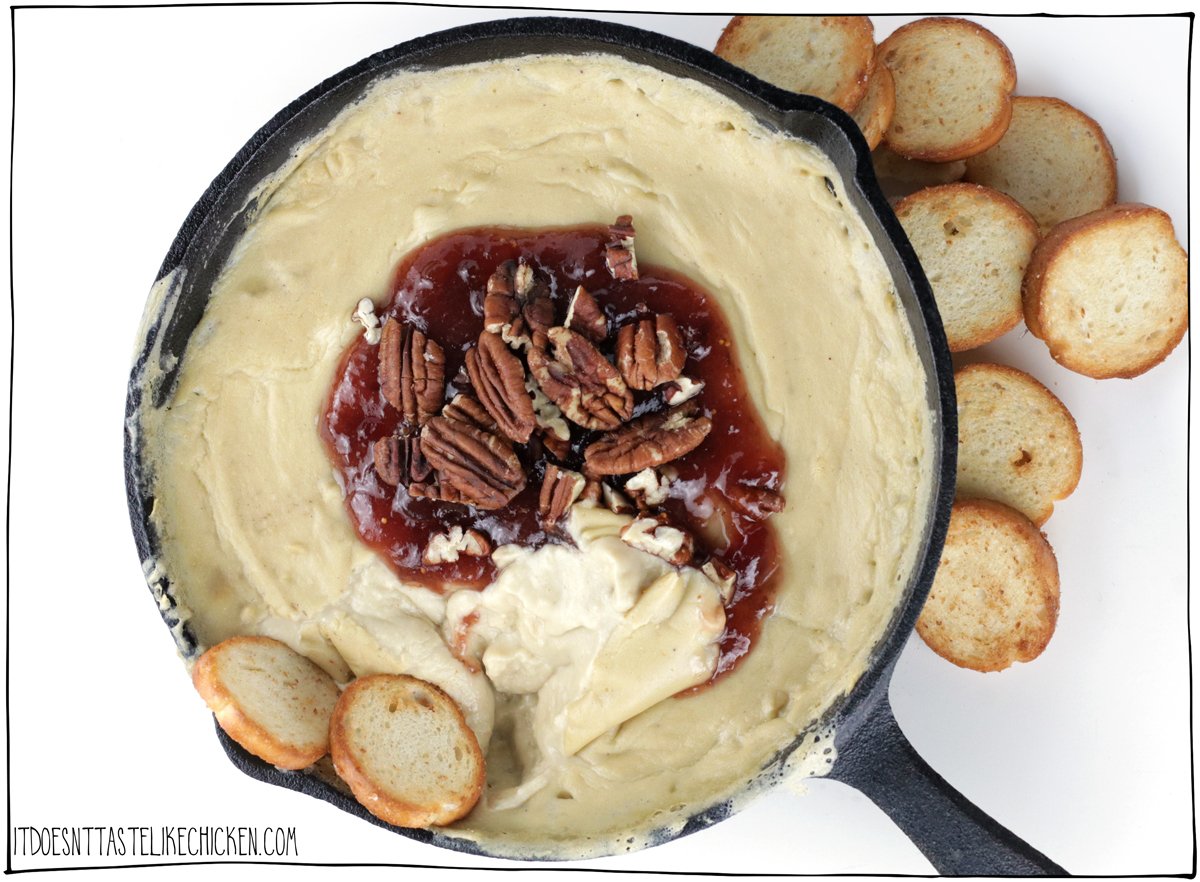 Did you know that you can make a homemade vegan baked brie dip with just 7 simple ingredients? You can, and wow is it amazingly delicious! Creamy, cheesy, gooey, and tastes just like brie except totally dairy free! This crowd-pleasing recipe is the perfect holiday party appetizer. #itdoesnttastelikechicken #vegancheese #veganappetizer