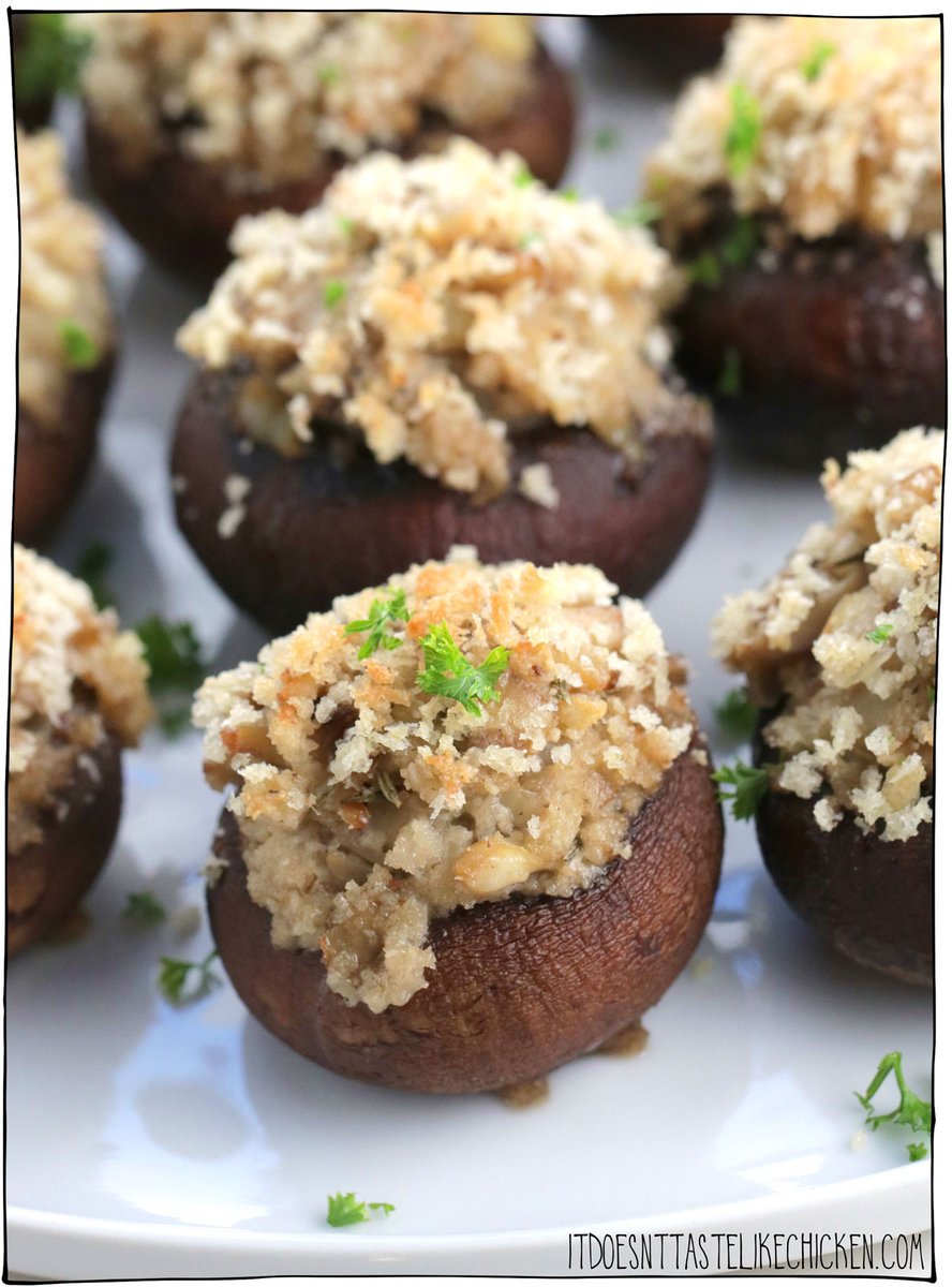 Easy Vegan Stuffed Mushrooms are the perfect party appetizer or they make a great side dish too!  They look fancy but are easy to make.  Mushroom caps are stuffed with vegan cream cheese, fried onions, garlic, panko and seasoning, then topped with more panko that bakes to a crispy golden topping.  These delicious, bite-sized, snacks are pop-so delicious!  #itdoesnttastelikechicken #veganappetizer #appetizer
