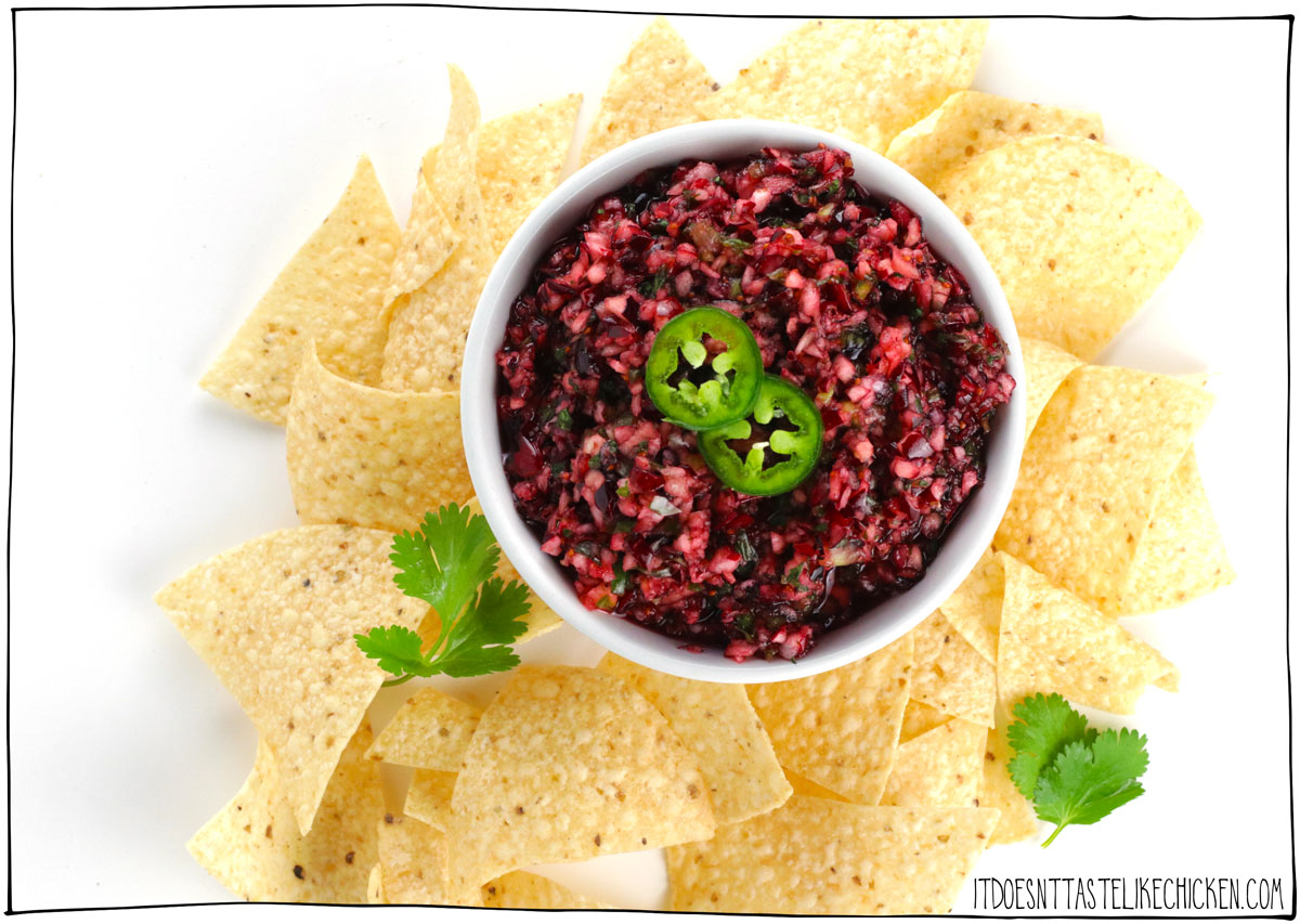 Just 5 minutes and 7 ingredients is all it takes to make this easy holiday appetizer! Cranberry salsa is fresh, tart, sweet, spicy, and super flavorful. This salsa tastes best when it rests in the fridge overnight making it a great make-ahead recipe. Serve it alone with tortilla chips or crackers, or you can pour it over a block of vegan cream cheese for a tart and creamy treat. #itdoesnttastelikechicken #veganappetizer #christmas #appetizer