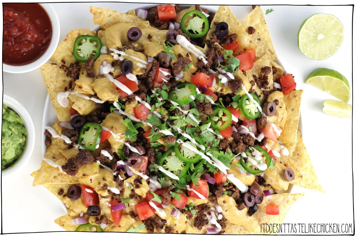The Best Loaded Vegan Nachos! Dive into the meatiest plant-based nachos you've ever had! Impossible™ Beef is crumbled, cooked, and seasoned with Mexican-inspired spices for the easiest and most delicious meaty topping. Then whip up a simple homemade plant-based nacho cheese and layer the cheese and meat on tortilla chips. Pile on all your favorite toppings to make The Best Loaded Nachos! YUM. #itdoesnttastelikechicken #vegan #sponsored