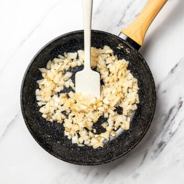 Cooking onions in skillet.