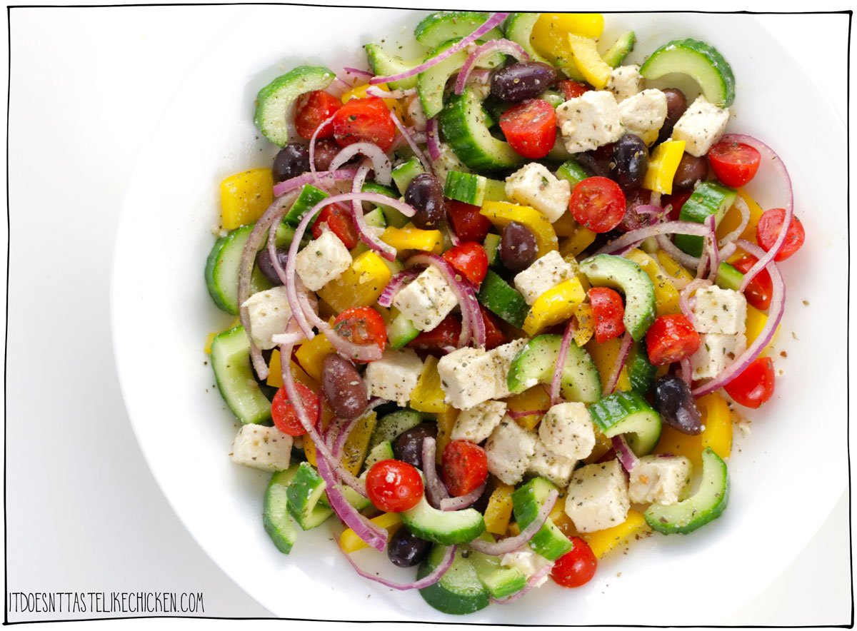Just 6 ingredients and a simple dressing are all you need to make the BEST Vegan Greek Salad! Just chop the veggies, shake up the dressing, toss the salad, and enjoy. This fresh and flavorful dish is the perfect recipe to enjoy summer produce! #itdoesnttastelikechicken #veganrecipes #dairyfree