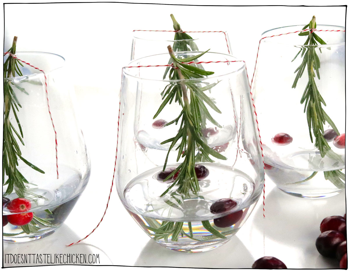 Add a few cranberries or pomegranate seeds to each glass then fill the glasses with one to two inches of water.