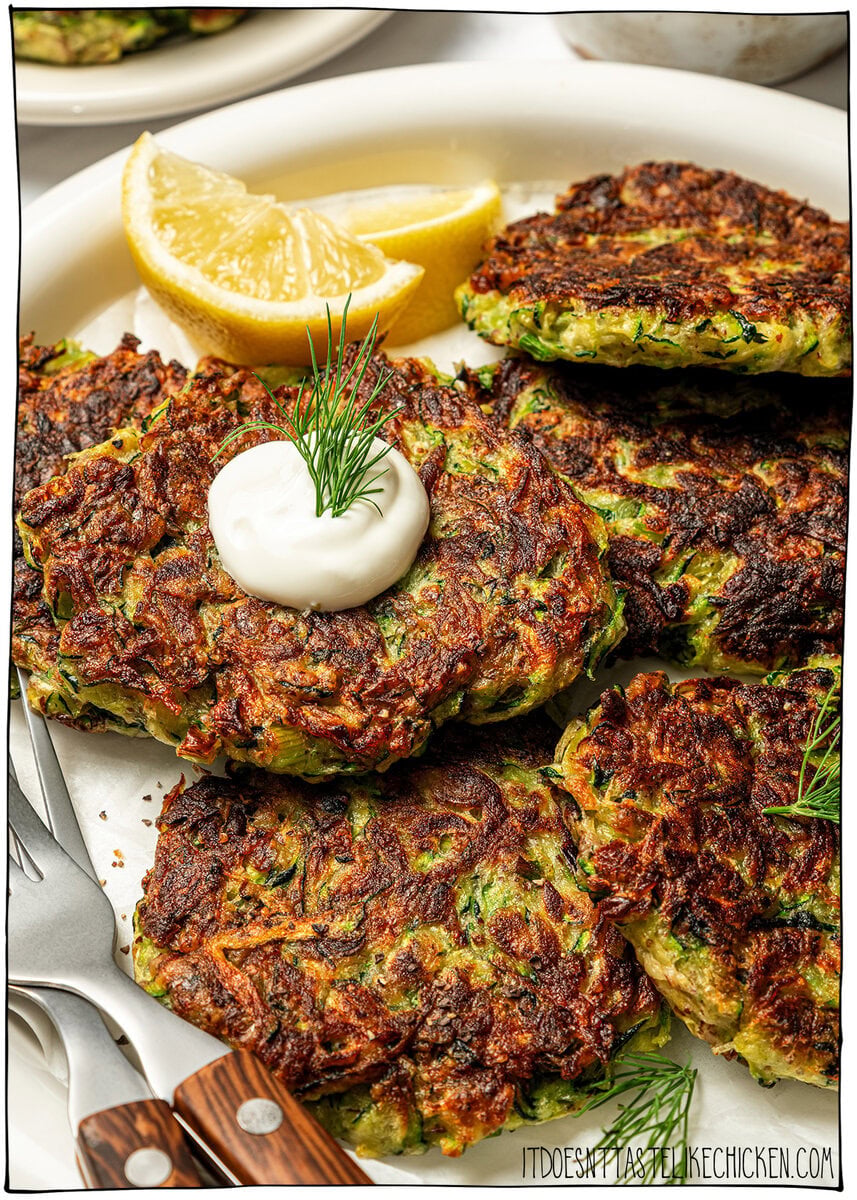 Crispy zucchini fritters on plate.