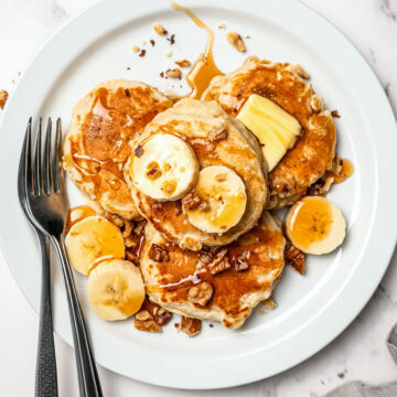 Overhead plate of banana oat pancakes with forks.