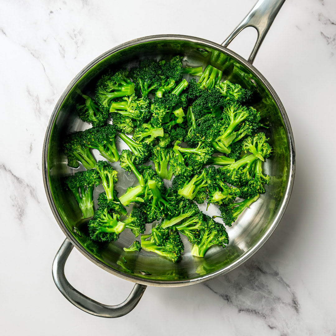 This easy Vegan Broccoli Rice Casserole is a crowd-pleaser with creamy cheese sauce, broccoli and fluffy rice. Works as a main dish or side! Blanched broccoli in pan.