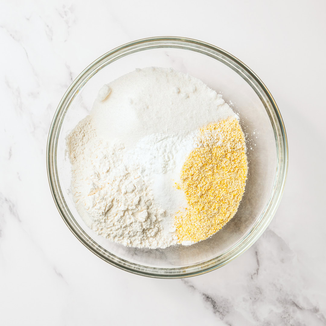 Dry ingredients for vegan spoon bread in glass bowl.