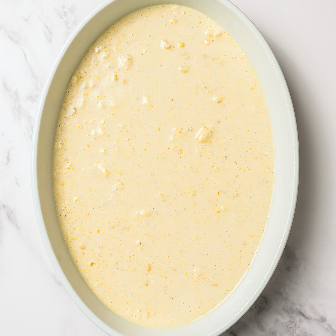 Spoon bread batter in casserole dish.