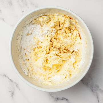 Powdered sugar added to ingredients for vegan buttercream frosting.