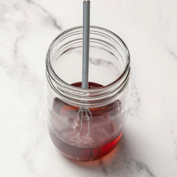 Whisking liquid ingredients in jar for rum balls.