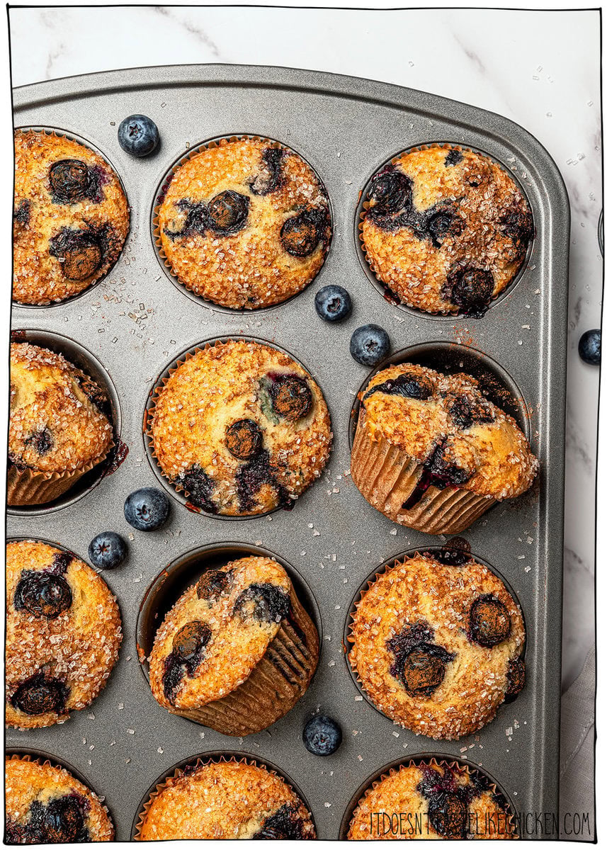 These bakery-style vegan blueberry muffins are made in one bowl, super easy! They're soft, fluffy, and finished with a crunchy sugar top. Pan of vegan blueberry muffins.