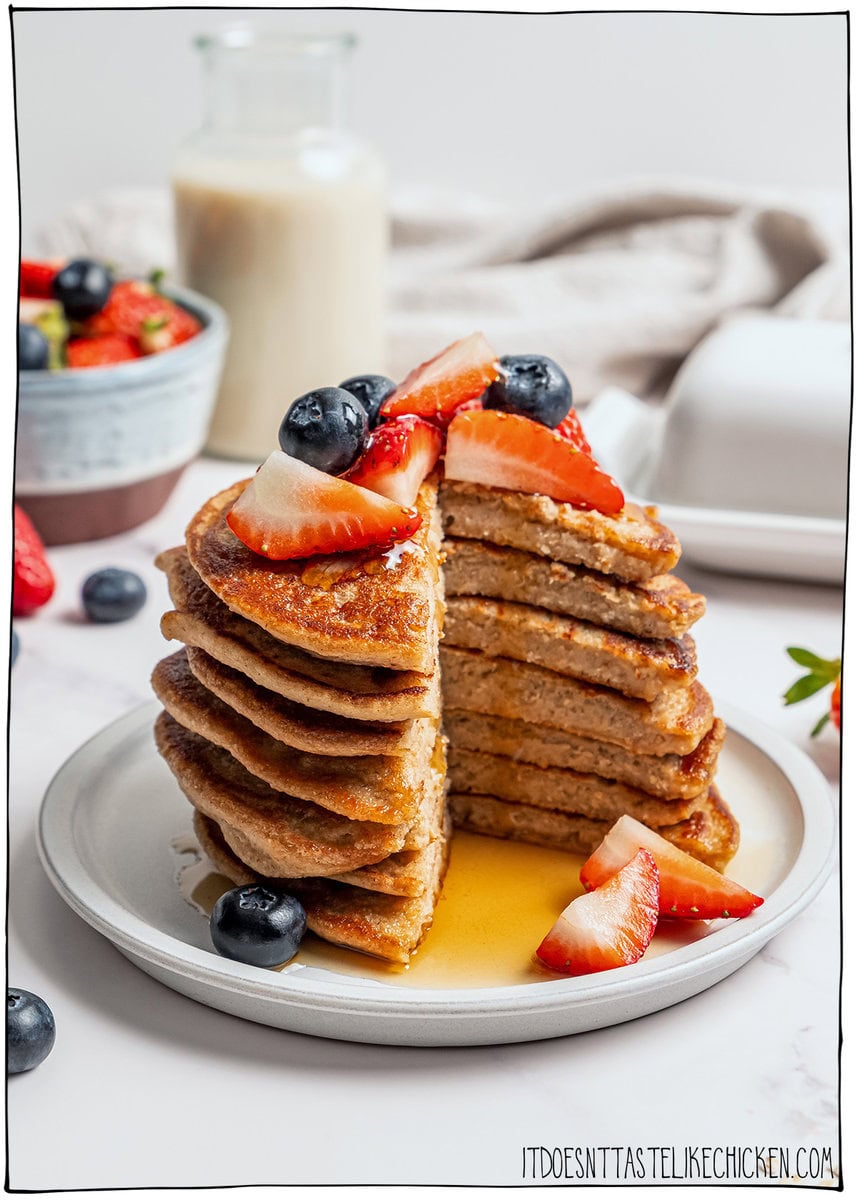 These fluffy vegan protein pancakes are mixed in the blender for an easy healthy breakfast with skillet or sheet-pan options. Gluten-free too! Stack of vegan protein pancakes with slice cut out to show fluffy texture.