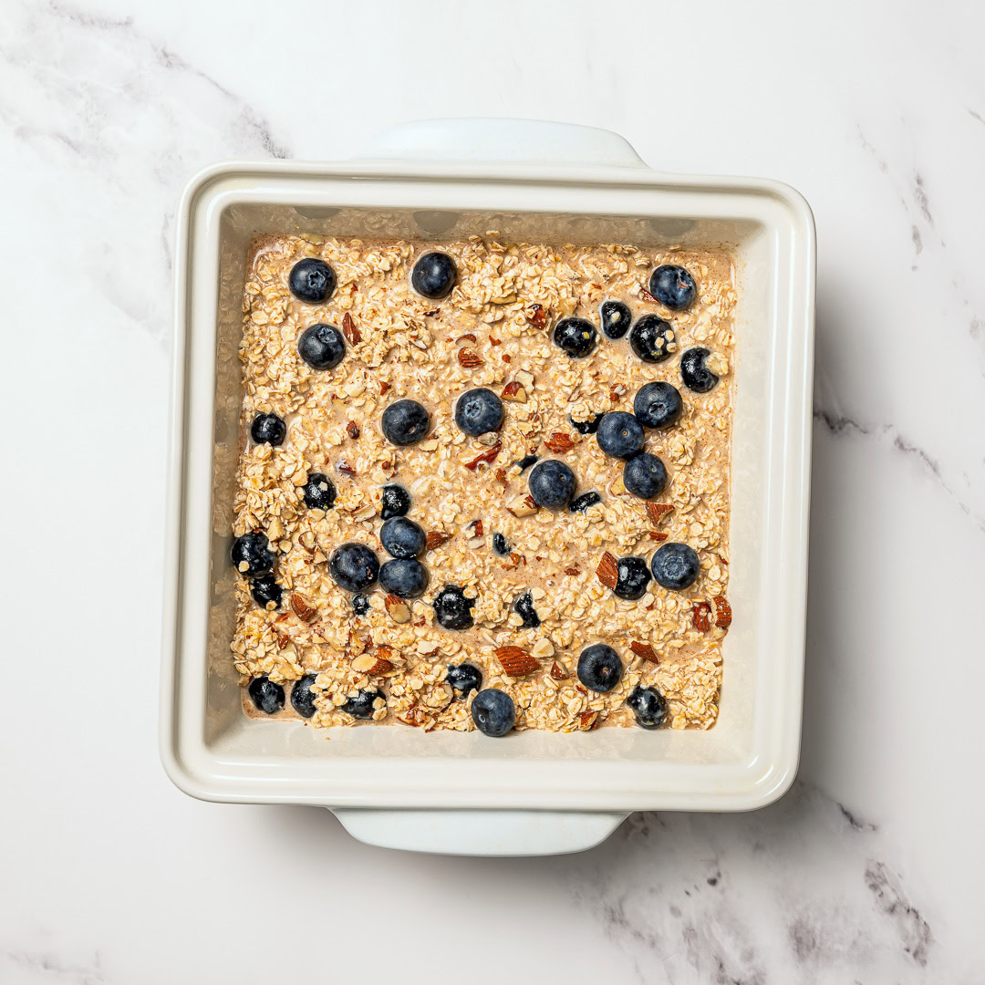 This cozy vegan baked oatmeal is easy to make, customizable, and perfect for meal prep. Mix in one bowl and enjoy any flavor combo! Baked oatmeal in baking dish.