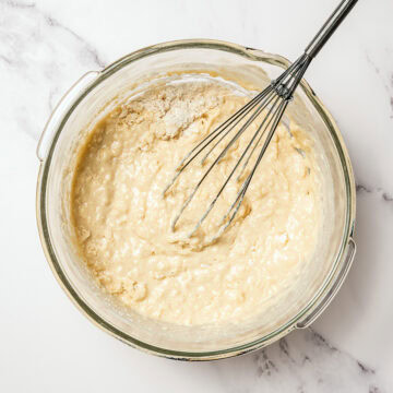 Muffin batter in mixing bowl with whisk.