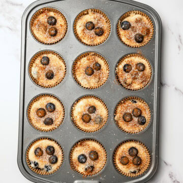 Unbaked vegan blueberry muffins in pan.