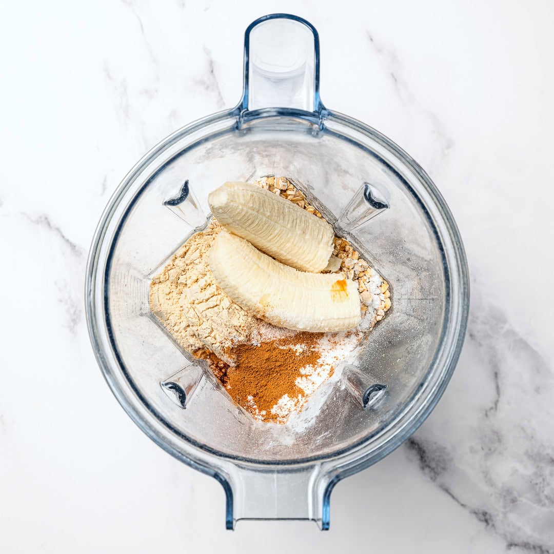 These fluffy vegan protein pancakes are mixed in the blender for an easy healthy breakfast with skillet or sheet-pan options. Gluten-free too! Ingredients for vegan protein pancakes added to blender.