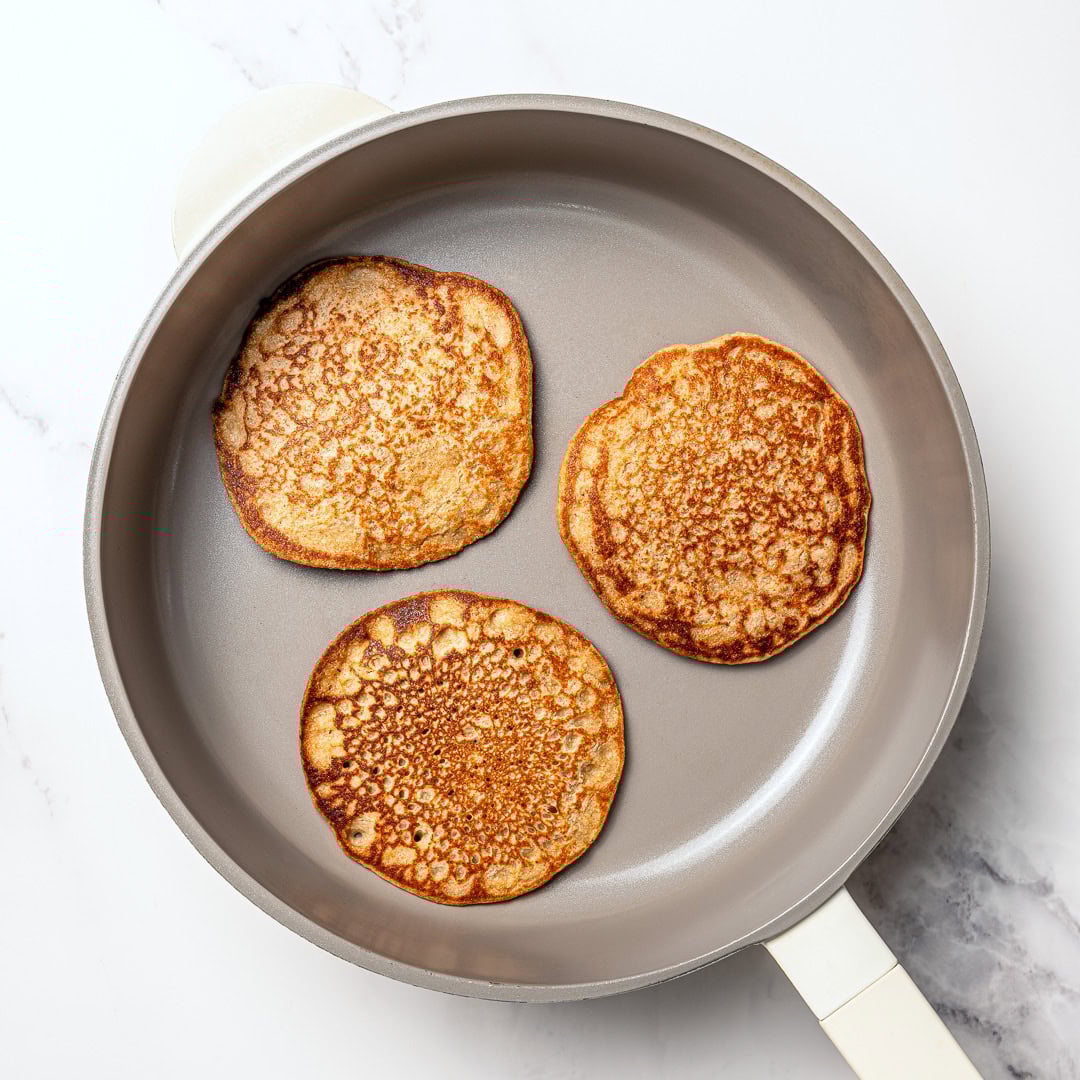 These fluffy vegan protein pancakes are mixed in the blender for an easy healthy breakfast with skillet or sheet-pan options. Gluten-free too! 3 vegan protein pancakes in skillet