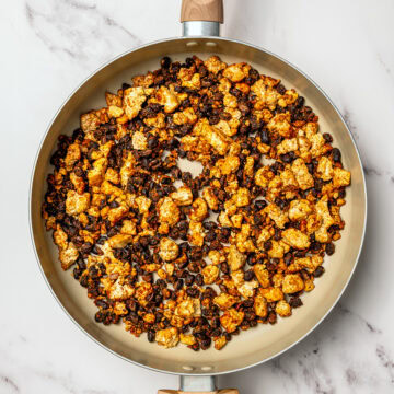 Scrambled tofu and black beans in skillet.
