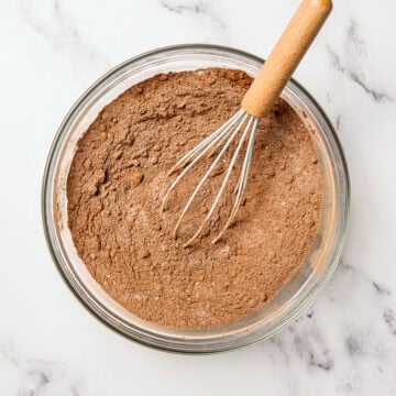 Whisk in bowl of dry ingredients for vegan chocolate cupcakes.
