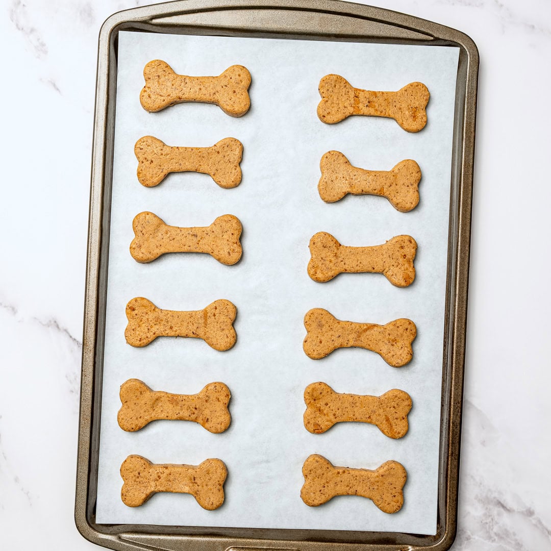 These quick and easy homemade soft dog treats use just 5 simple ingredients and bake up chewy, peanut buttery, and pup-approved! Homemade dog treats on parchment-lined pan.